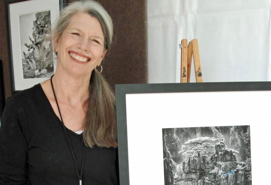 Jodie Hulden displaying her black and white photo of Presence