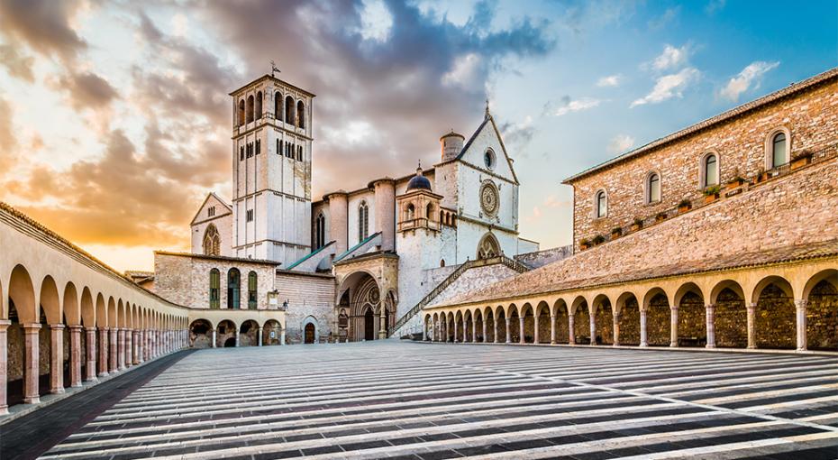 Famous Basilica of St. Francis of Assisi (Basilica Papale di San Francesco) with Lower Plaza at sunset in Assisi, Umbria, Italy.— Photo by pandionhiatus3