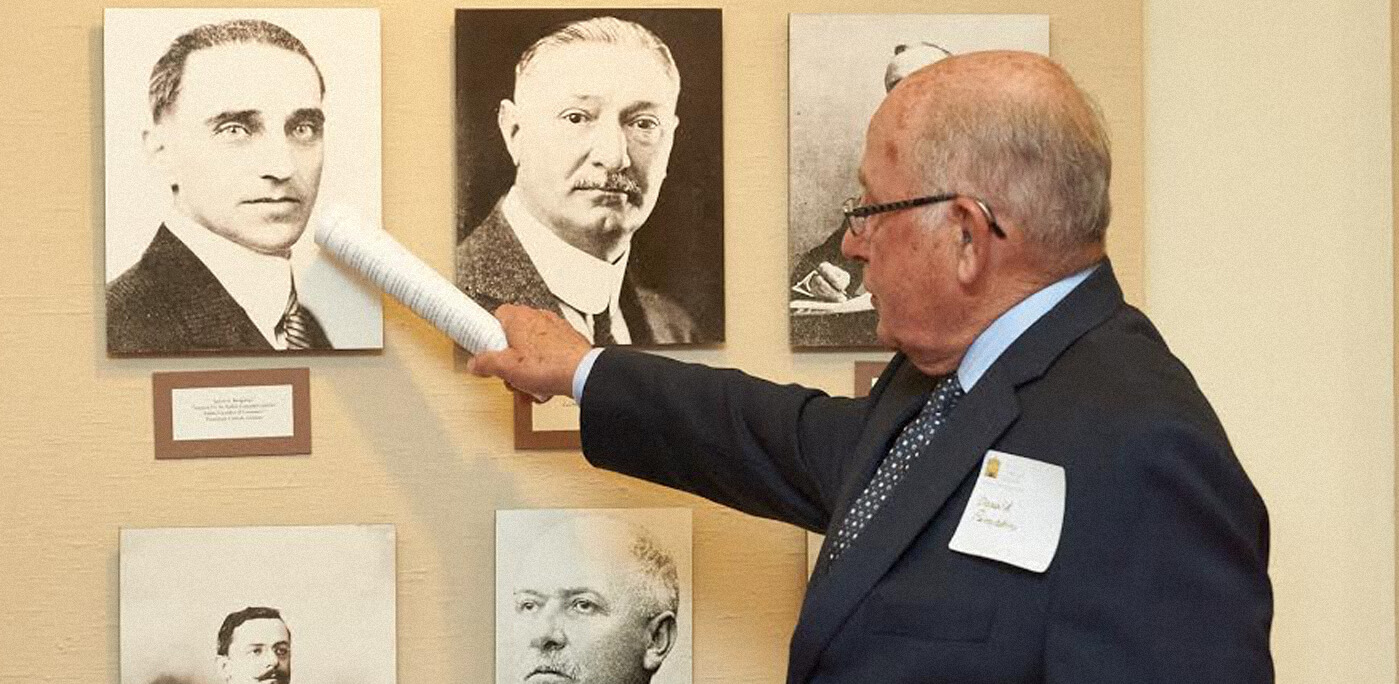 CS Board President, Donald G. Parachini, points to photographs of the original ICS board members. Photo by by Vladimir Petrochenko