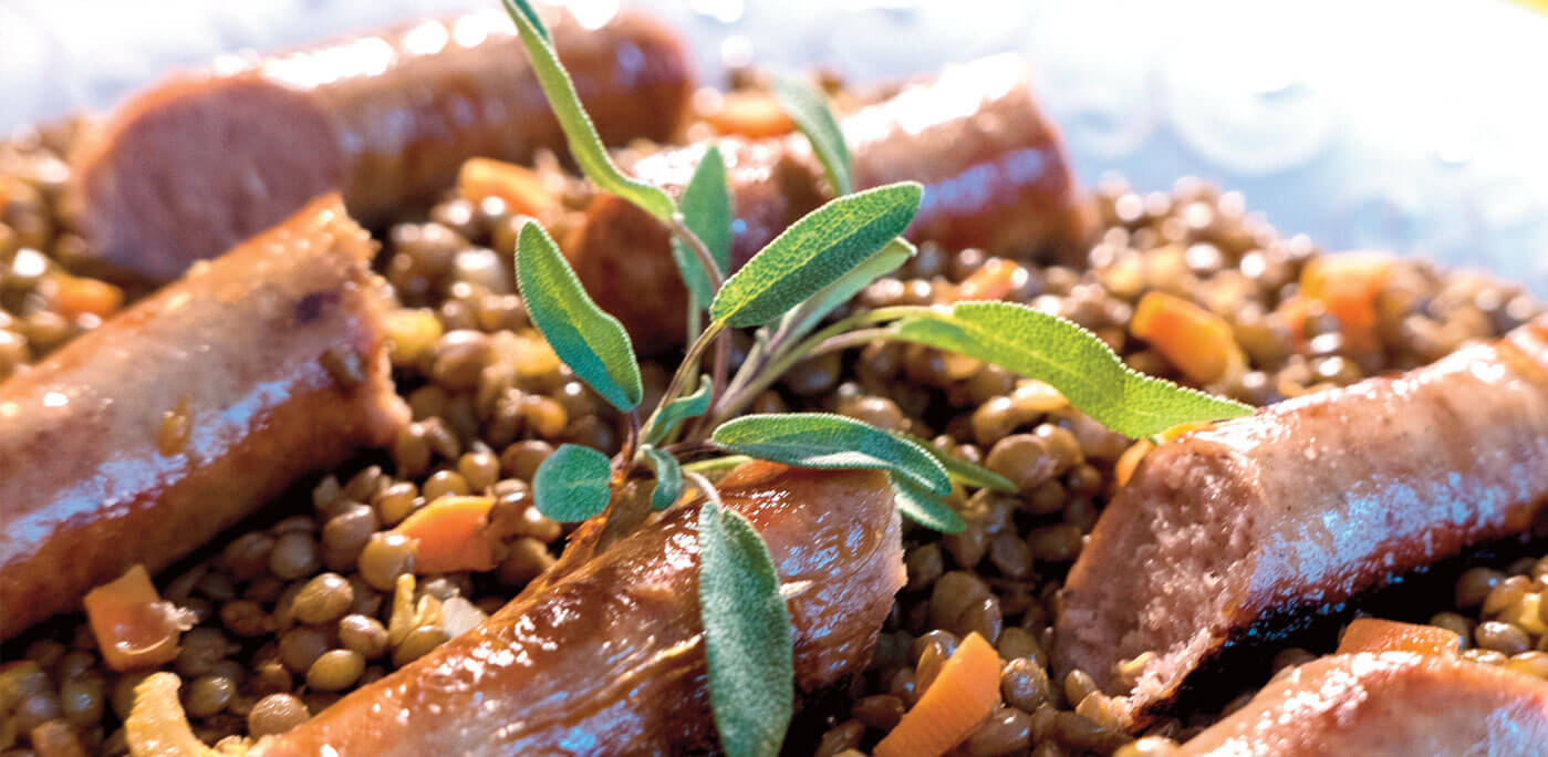 Pork sausages atop braised lentils. | Copyright Nathan Hoyt/Forktales 2016 