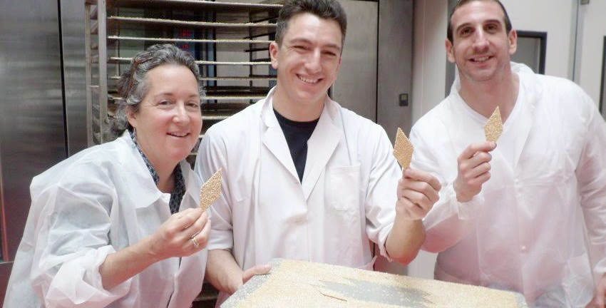 Hands-on quality control is what makes Ritrovo products successful. Owner Ilyse Rathet tests a Tavolozze cracker with the help of Figuli's Filippo Albertini (center) and distributor Marco Damiani