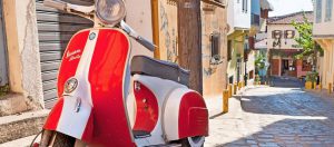 Vespa scooter parked in the street of Rome. Photo by efesenko