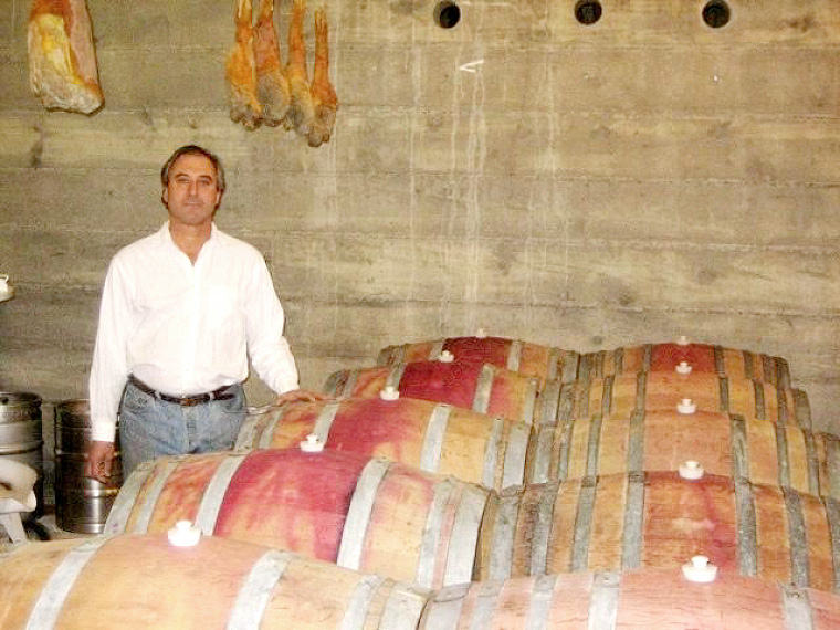 John Chiarito in the cellar with his wine & the hanging prosciutto he made. Photo courtesy of John Chiarito